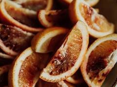 Blood orange wedges in a dark bowl.