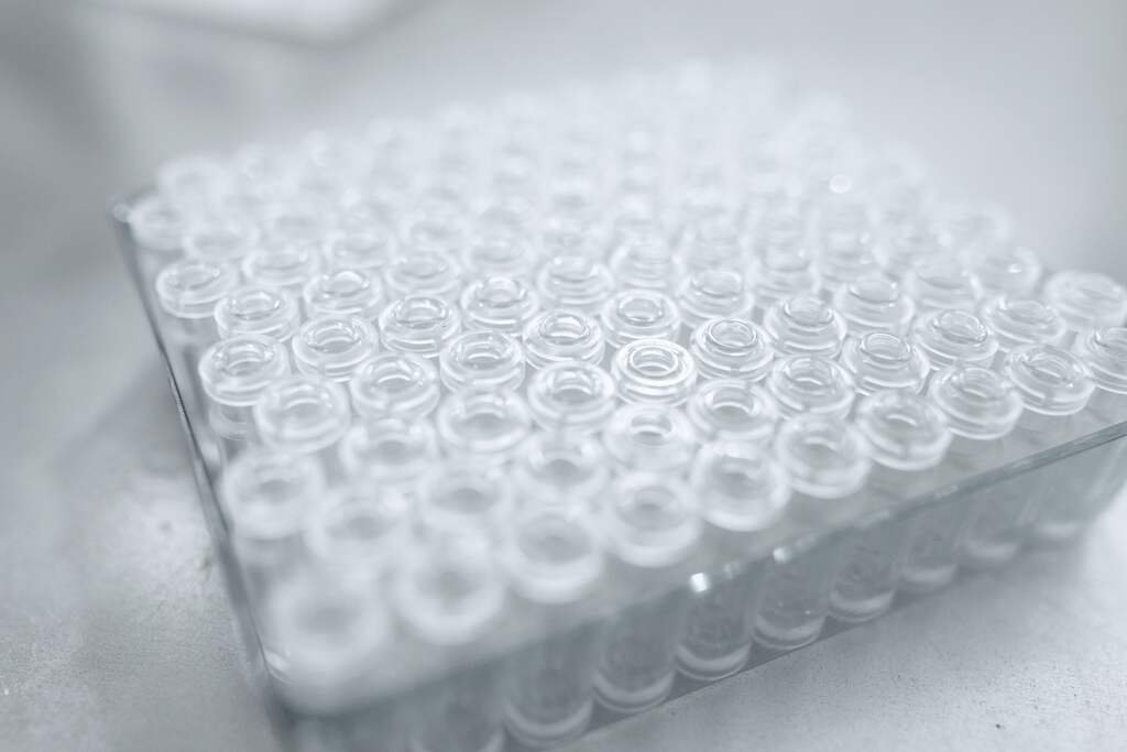 A rack of small clear glass vials from a formulation screen, seen close.
