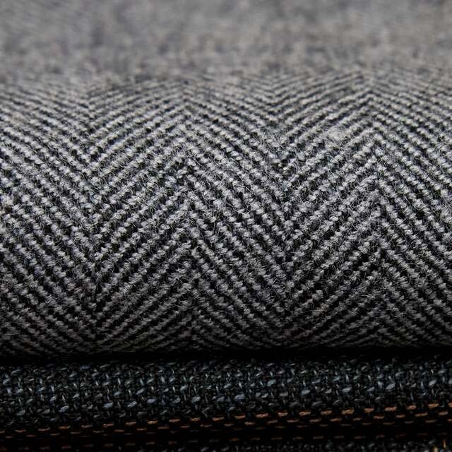 Grey herringbone twill folded over a darker cloth.